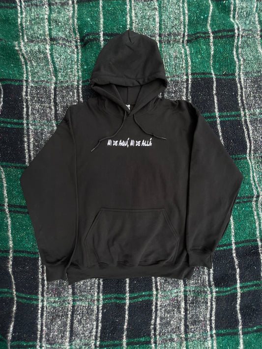 Black hoodie with text on a green and black plaid background